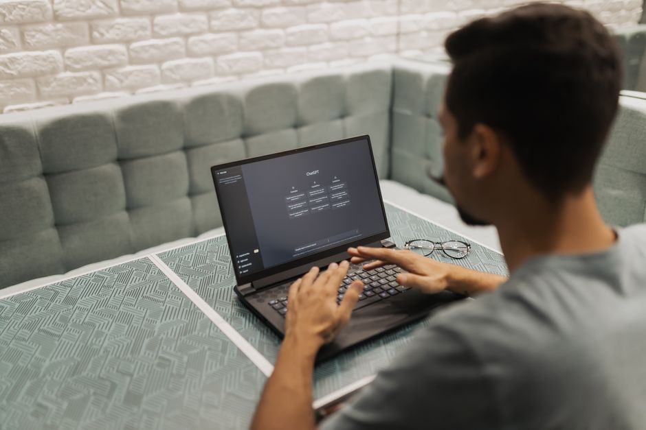 Professional working on a laptop with AI productivity tools in a modern workspace